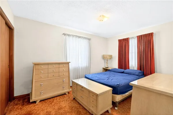 a bedroom with a bed and a view of bathroom