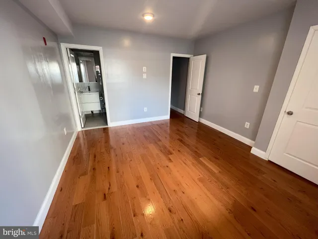 wooden floor in an empty room with a mirror