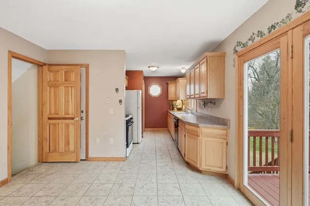a kitchen with stainless steel appliances granite countertop a refrigerator and a sink