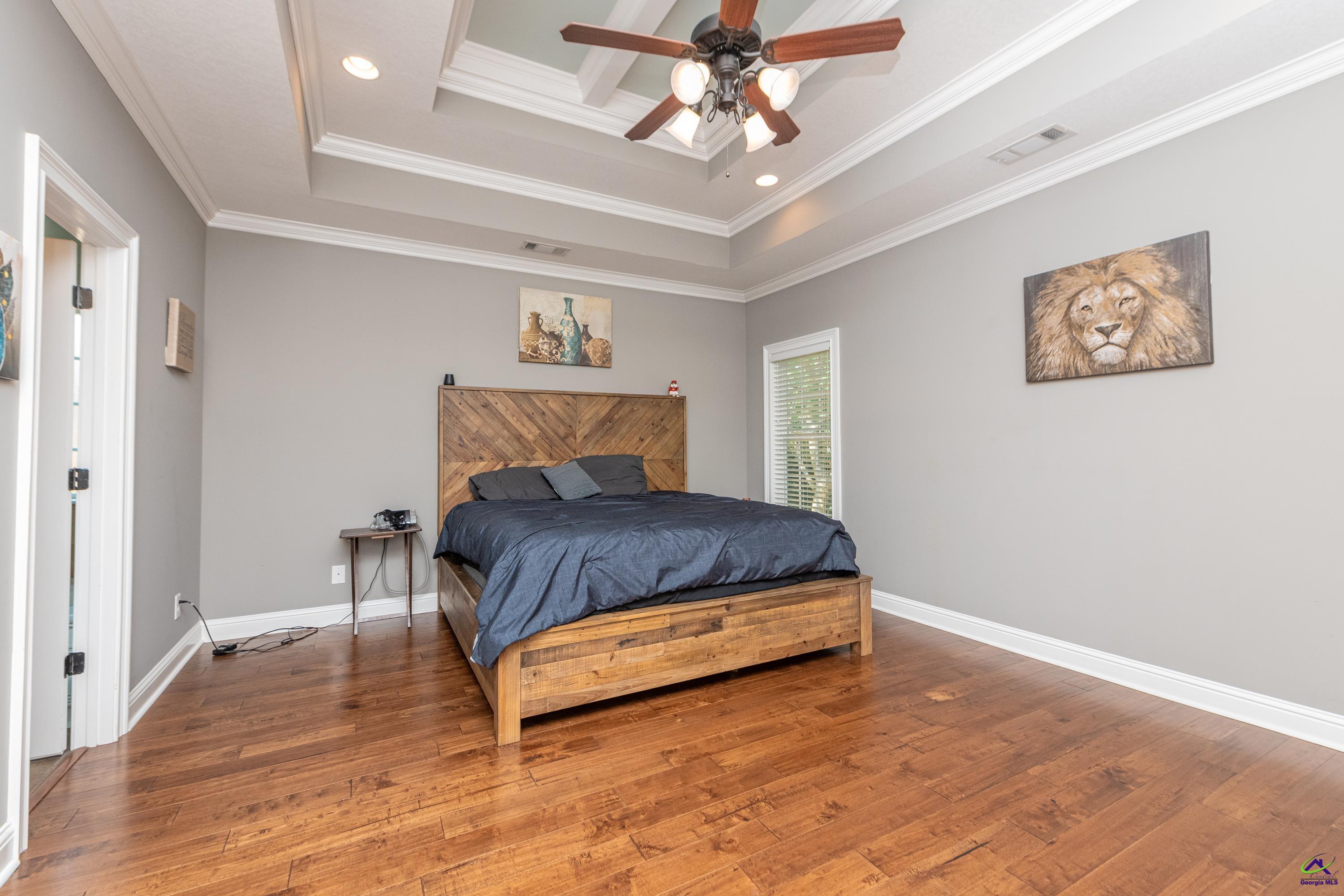 405 Old Bridge Road Warner Robins, GA 31088 - Photo 20 of 58 a bedroom with a bed and a chandelier