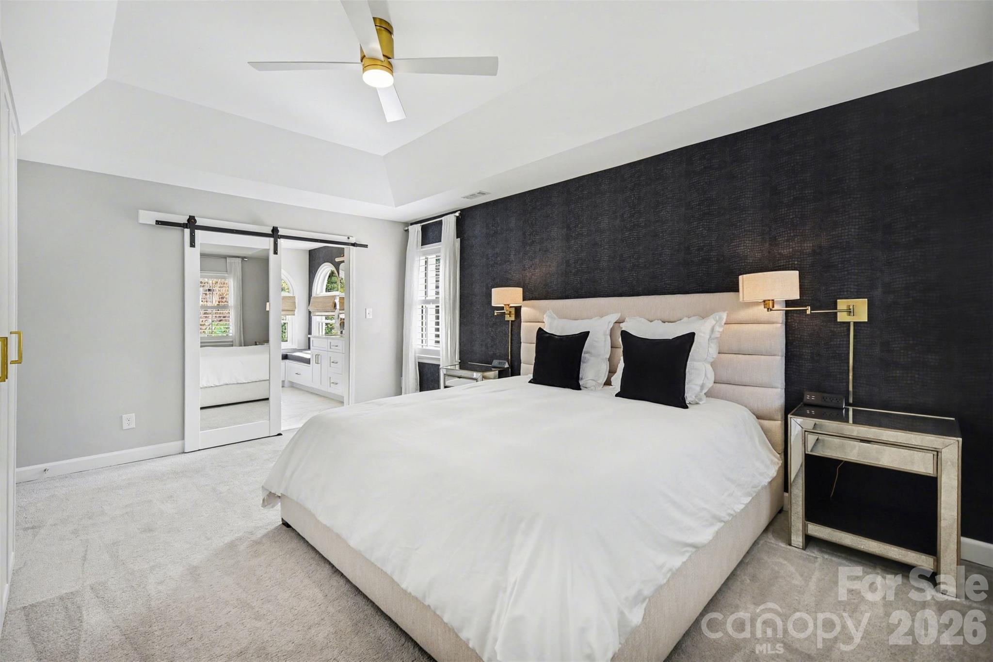 6008 Alexa Road Charlotte, NC 28277 - Photo 20 of 46 a bedroom with a bed and a chandelier