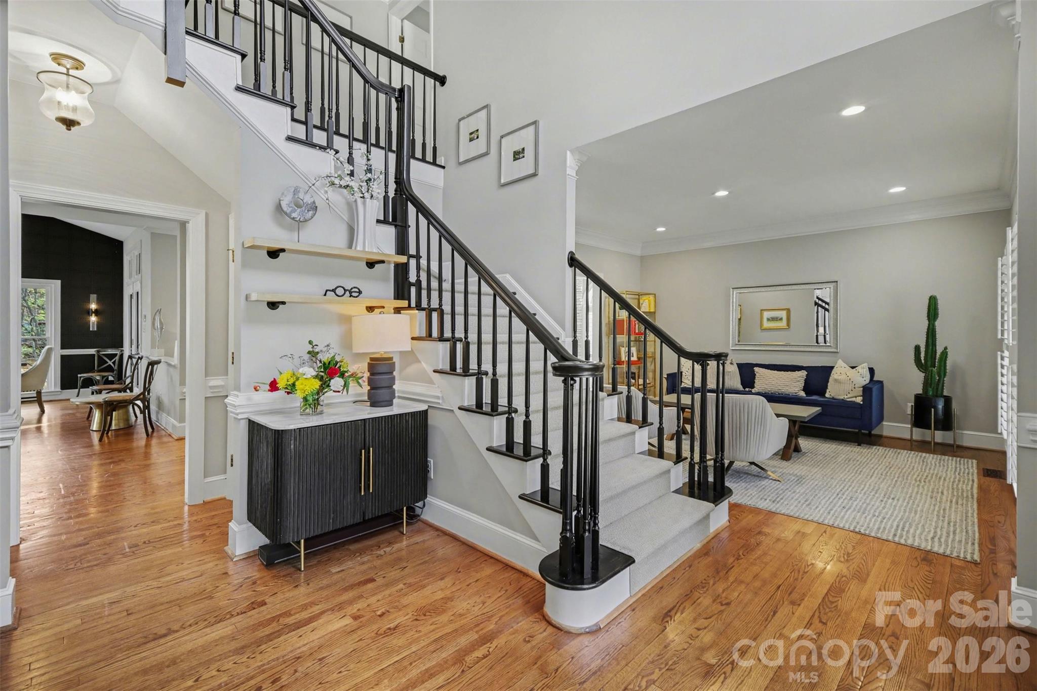 6008 Alexa Road Charlotte, NC 28277 - Photo 2 of 46 a living room with wooden floor and stairs