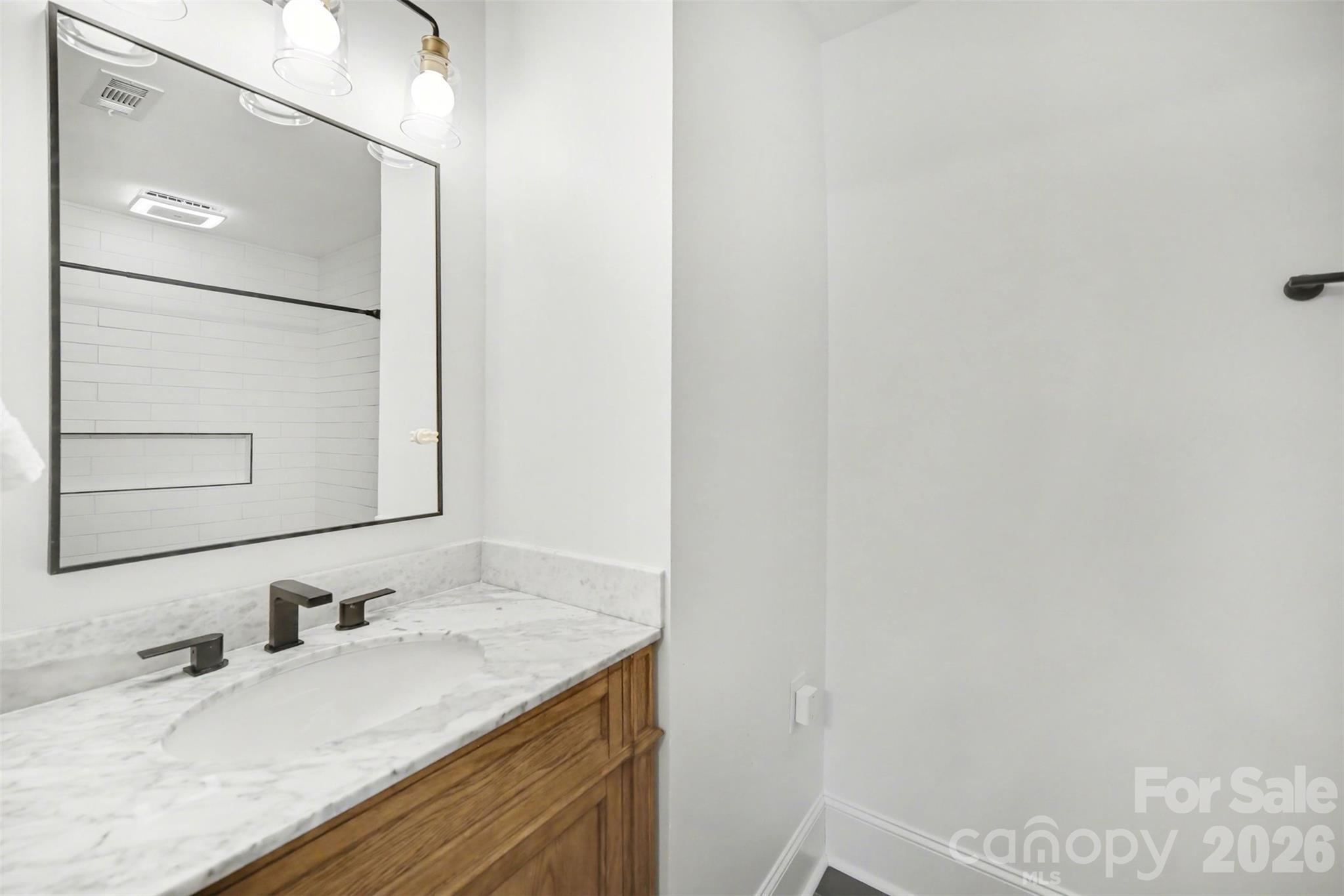 6008 Alexa Road Charlotte, NC 28277 - Photo 28 of 46 a bathroom with a granite countertop sink and a mirror