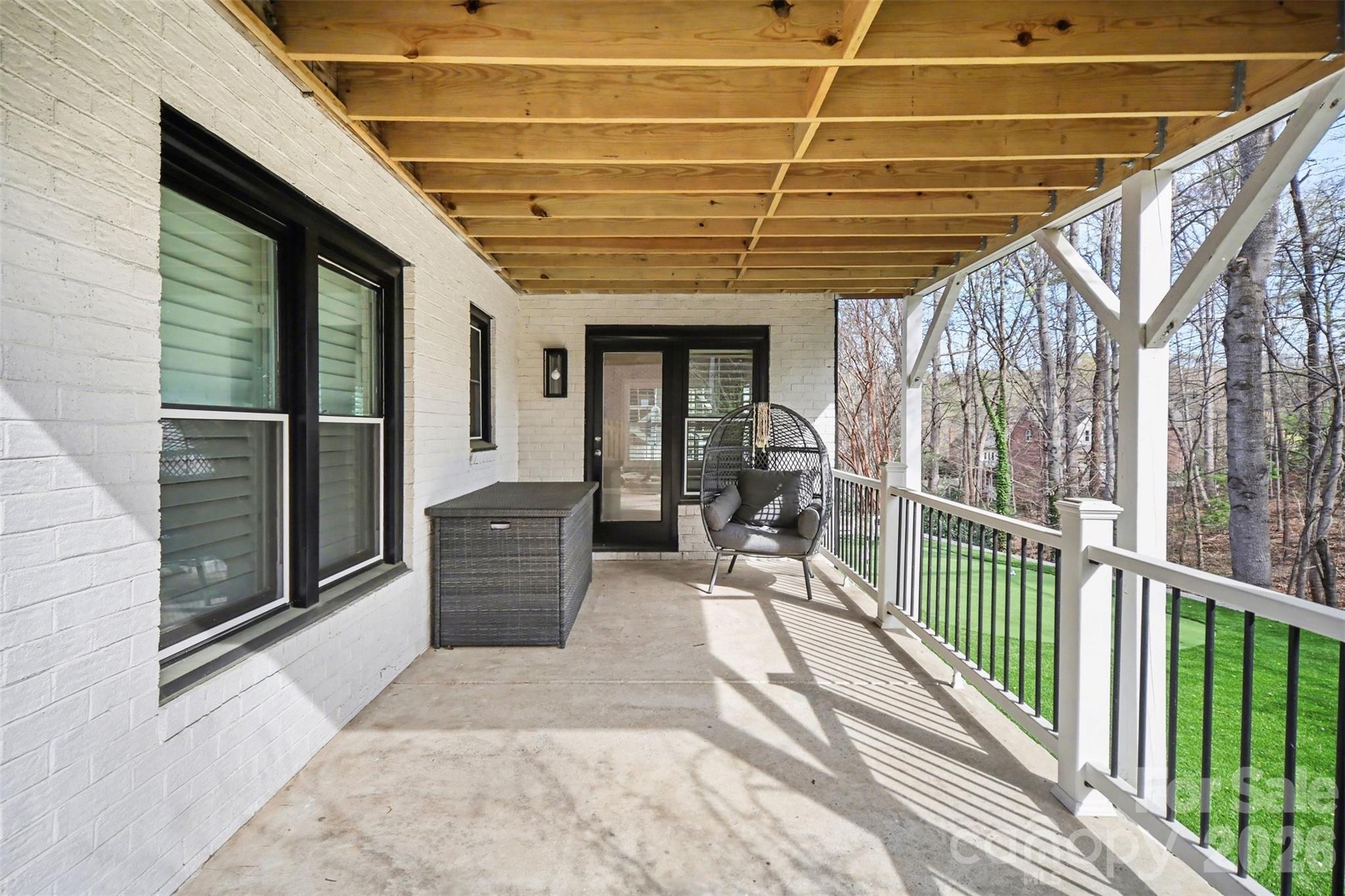 6008 Alexa Road Charlotte, NC 28277 - Photo 41 of 46 a view of a porch with wooden floor and iron stairs