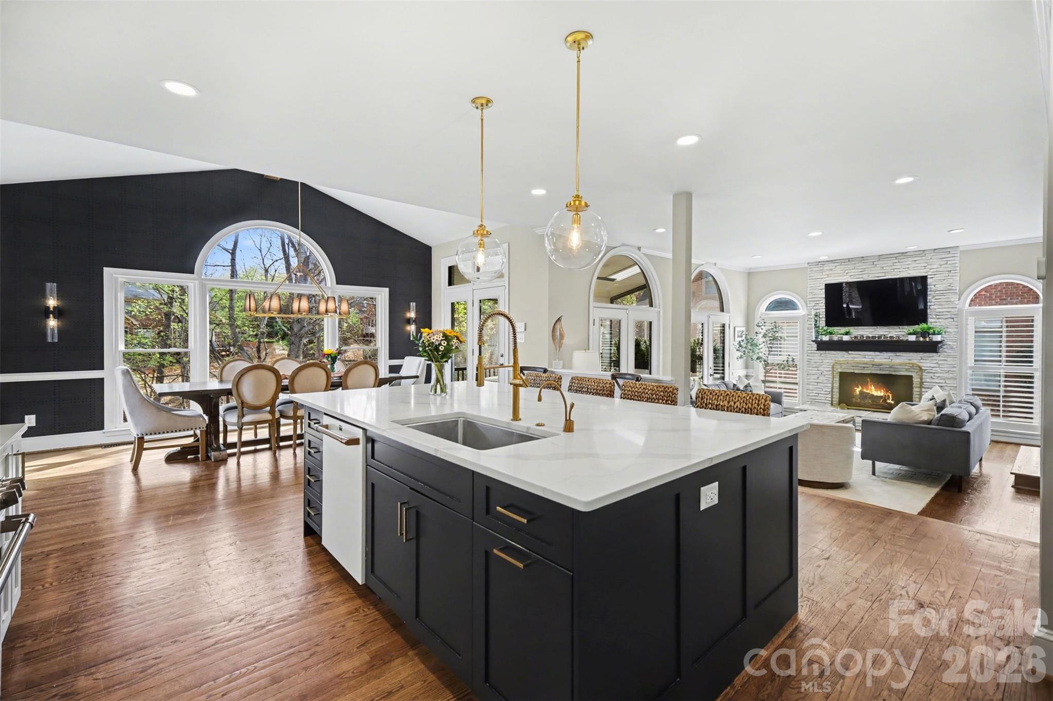 6008 Alexa Road Charlotte, NC 28277 - Photo 6 of 46 a kitchen with stainless steel appliances granite countertop a stove and a view of living room