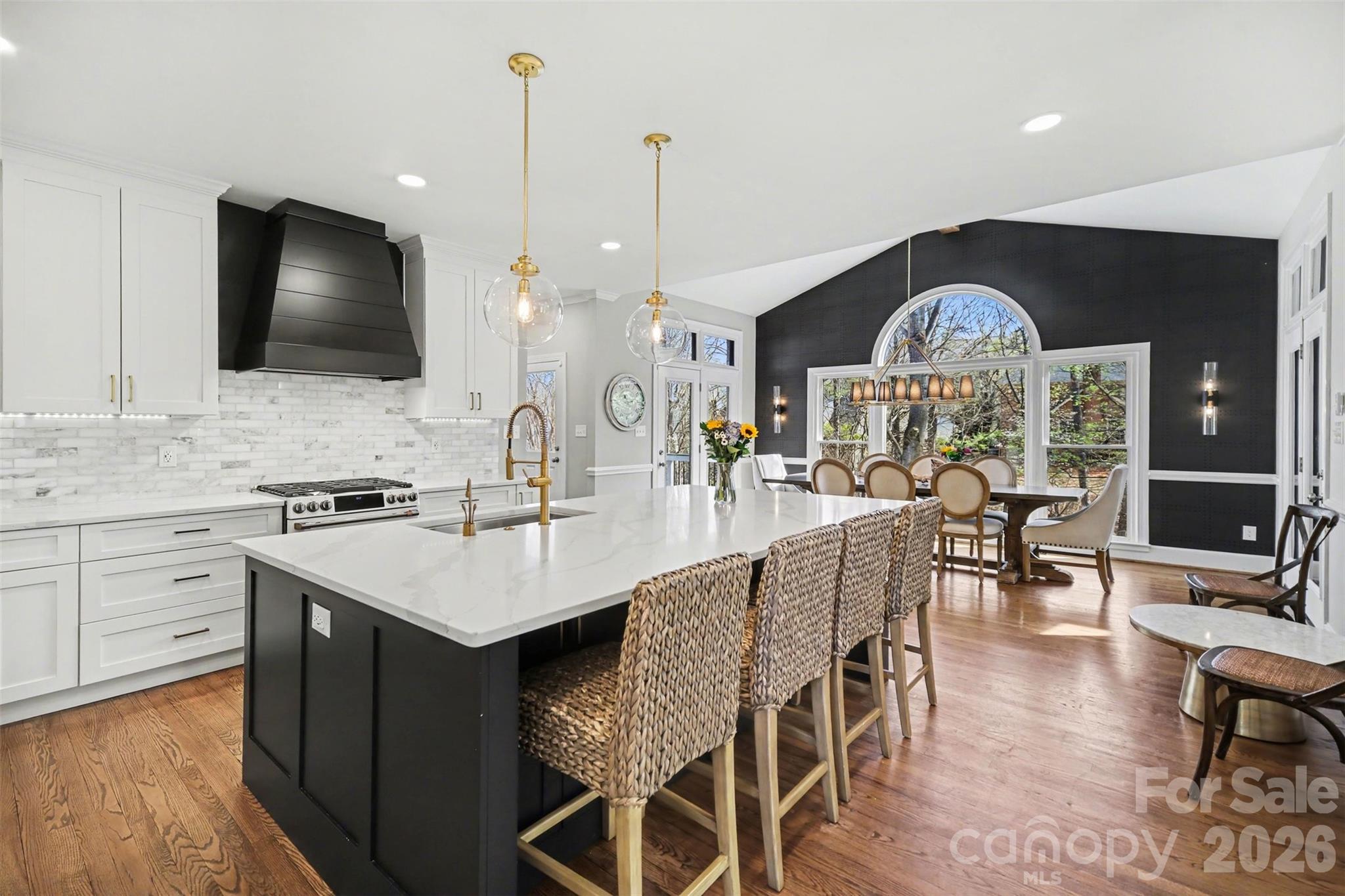 6008 Alexa Road Charlotte, NC 28277 - Photo 7 of 46 a kitchen with a dining table chairs cabinets and stainless steel appliances