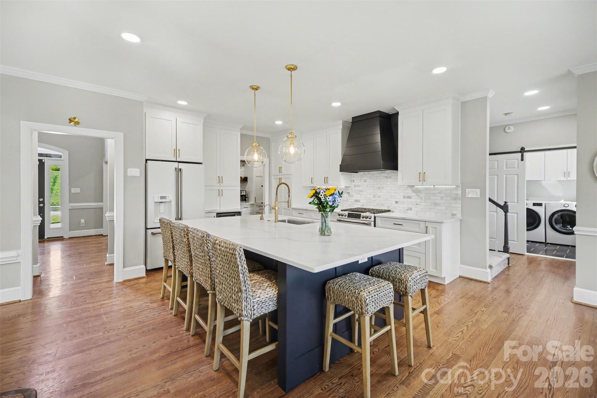 6008 Alexa Road Charlotte, NC 28277 - Photo 8 of 46 a kitchen with stainless steel appliances kitchen island granite countertop a table chairs and a refrigerator