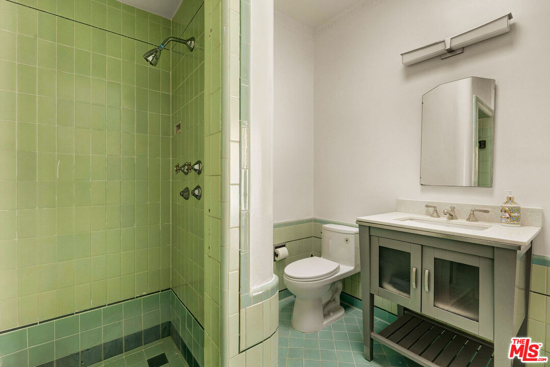 1326 Londonderry View Drive, Unit 7 Los Angeles, CA 90069 - Photo 18 of 21 a bathroom with a granite countertop toilet sink and mirror