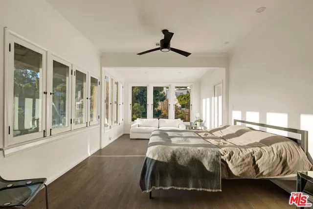 a bedroom with a bed and a large window