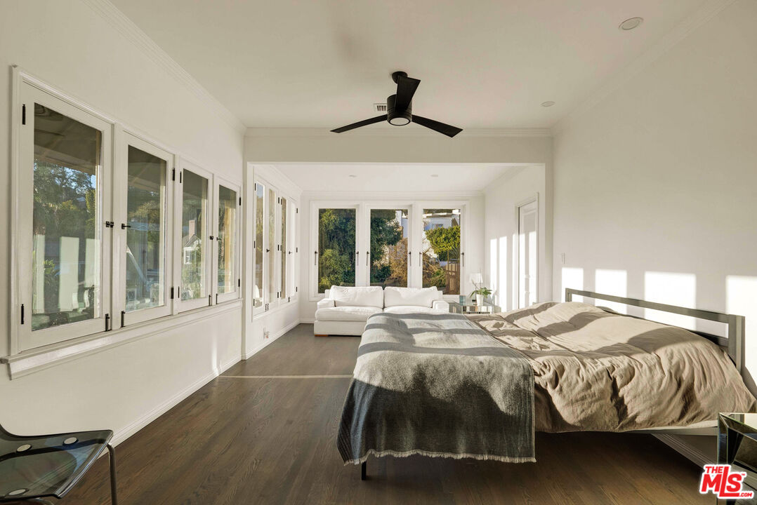 1326 Londonderry View Drive, Unit 7 Los Angeles, CA 90069 - Photo 19 of 21 a bedroom with a bed and a large window