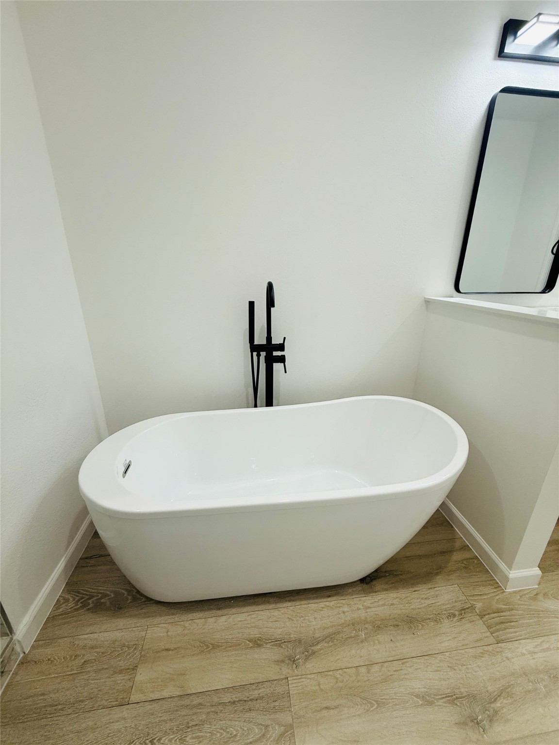 5214 Rue Street, Unit A B Houston, TX 77033 - Photo 11 of 13 a white bath tub sitting in a bathroom