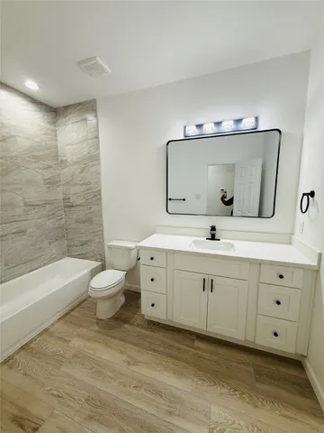 a spacious bathroom with a double vanity sink mirror and toilet