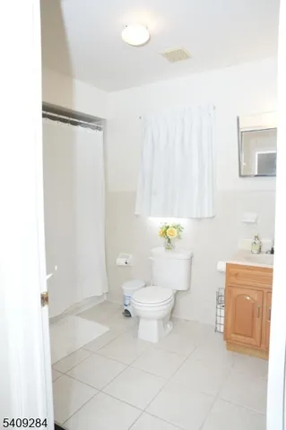 a bathroom with a toilet a sink and a shower