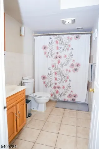 a bathroom with a toilet sink and shower