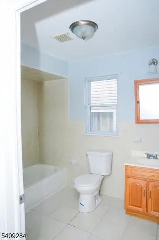a bathroom with a toilet a sink and bathtub