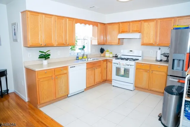 a kitchen with a stove top oven sink and cabinets