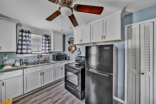a kitchen with stainless steel appliances a refrigerator sink and cabinets