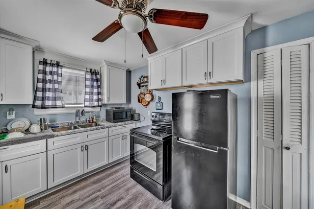 a kitchen with stainless steel appliances a refrigerator sink and cabinets