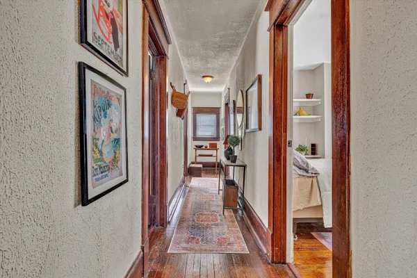 a view of a hallway view with wooden floor and staircase