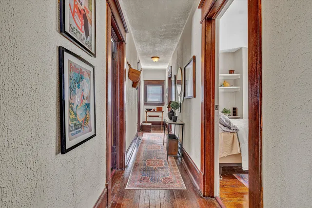 a view of a hallway view with wooden floor and staircase