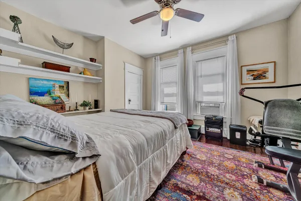 a bedroom with a bed a table and chair