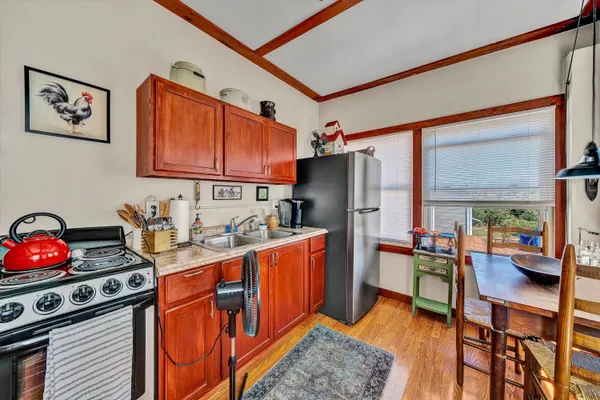 a kitchen with stainless steel appliances granite countertop a refrigerator a stove a sink and dishwasher