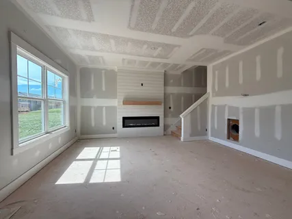 a big room with windows and fireplace