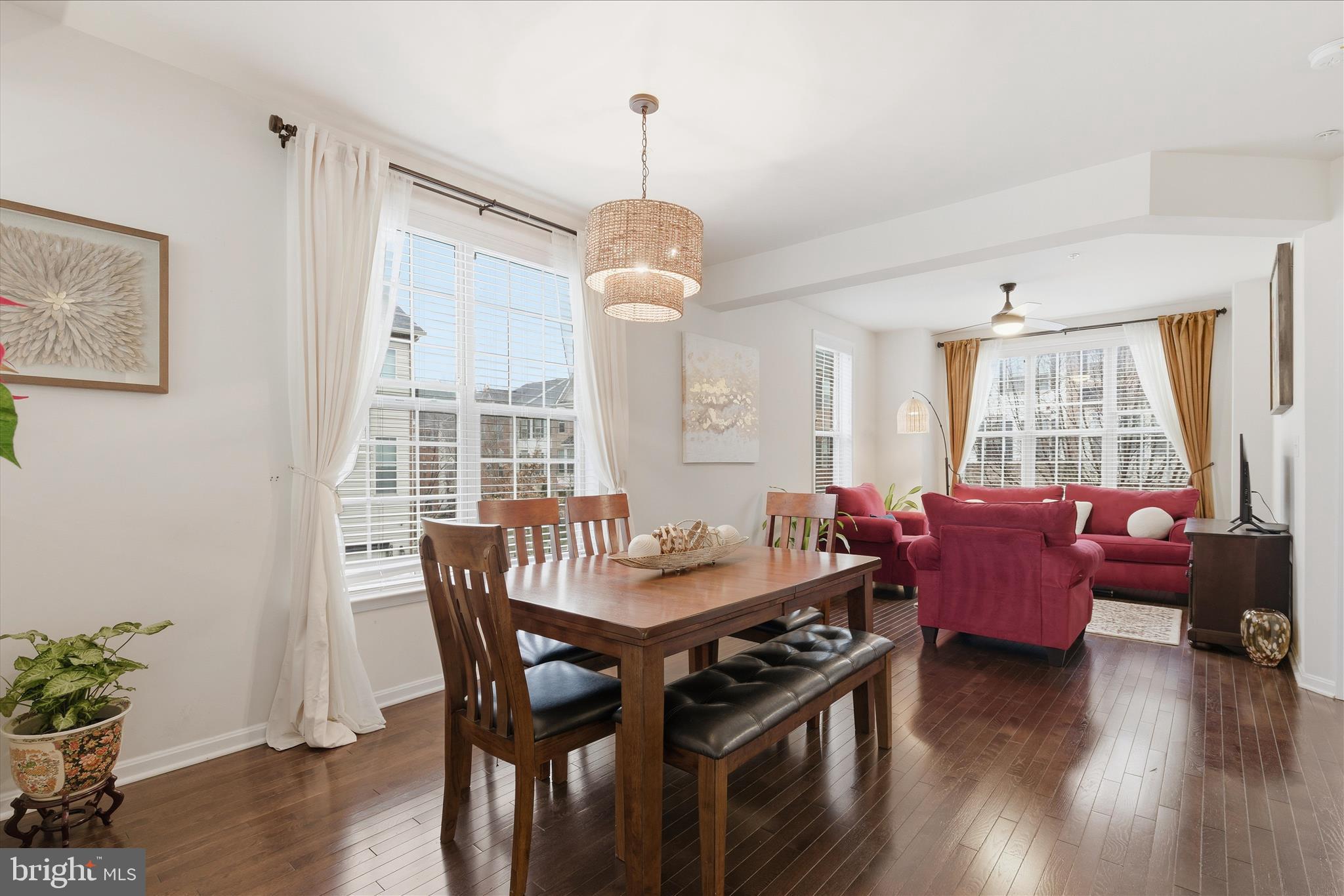 9511 Smithview Place Lanham, MD 20706 - Photo 13 of 33 a dining room with wooden floor a chandelier a wooden table and chairs