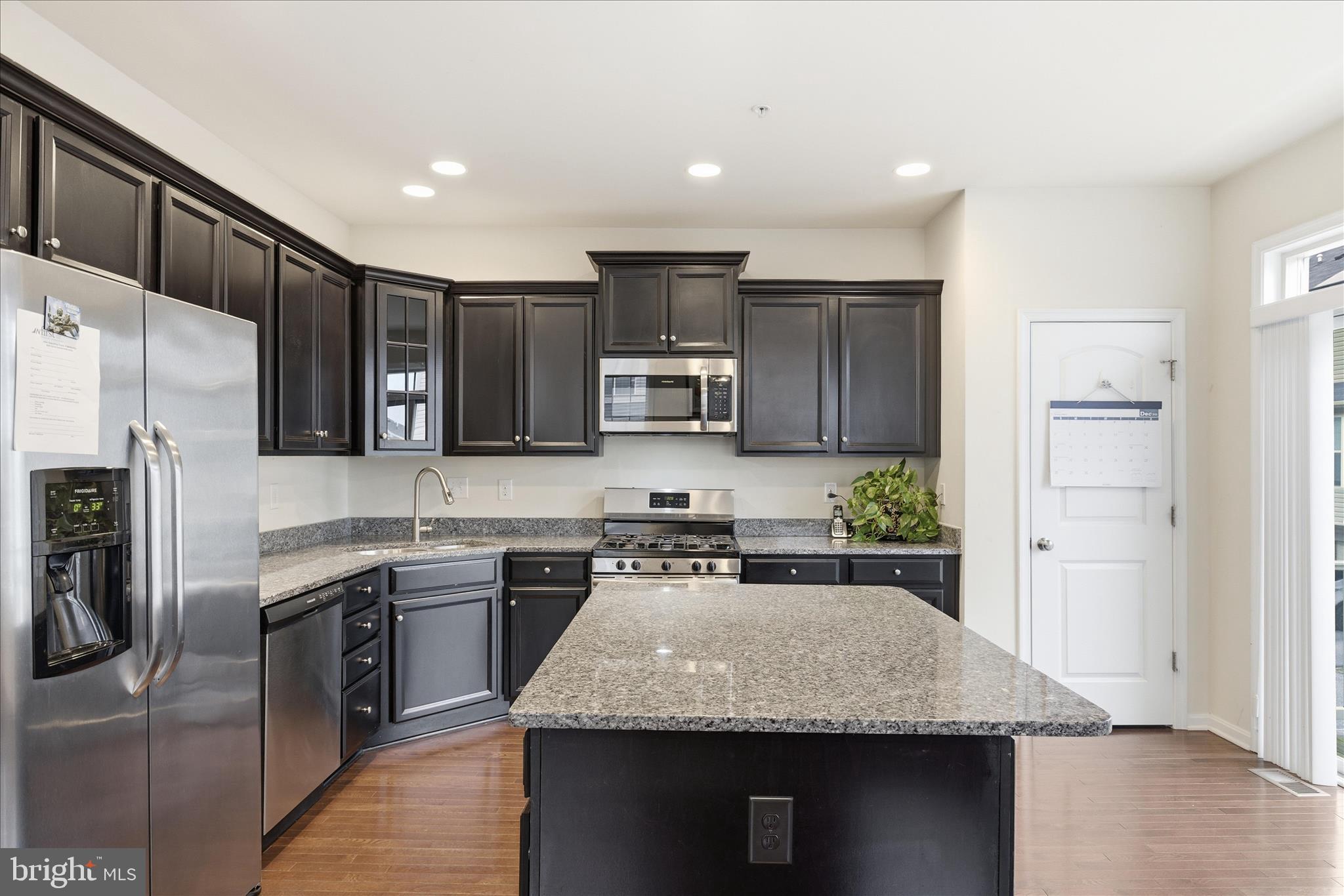 9511 Smithview Place Lanham, MD 20706 - Photo 17 of 33 a kitchen with stainless steel appliances granite countertop a sink stove and refrigerator