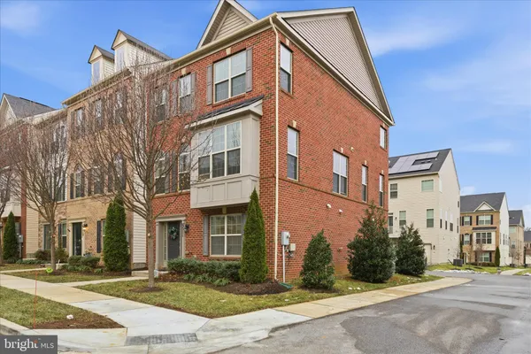 a front view of a residential apartment building with a yard