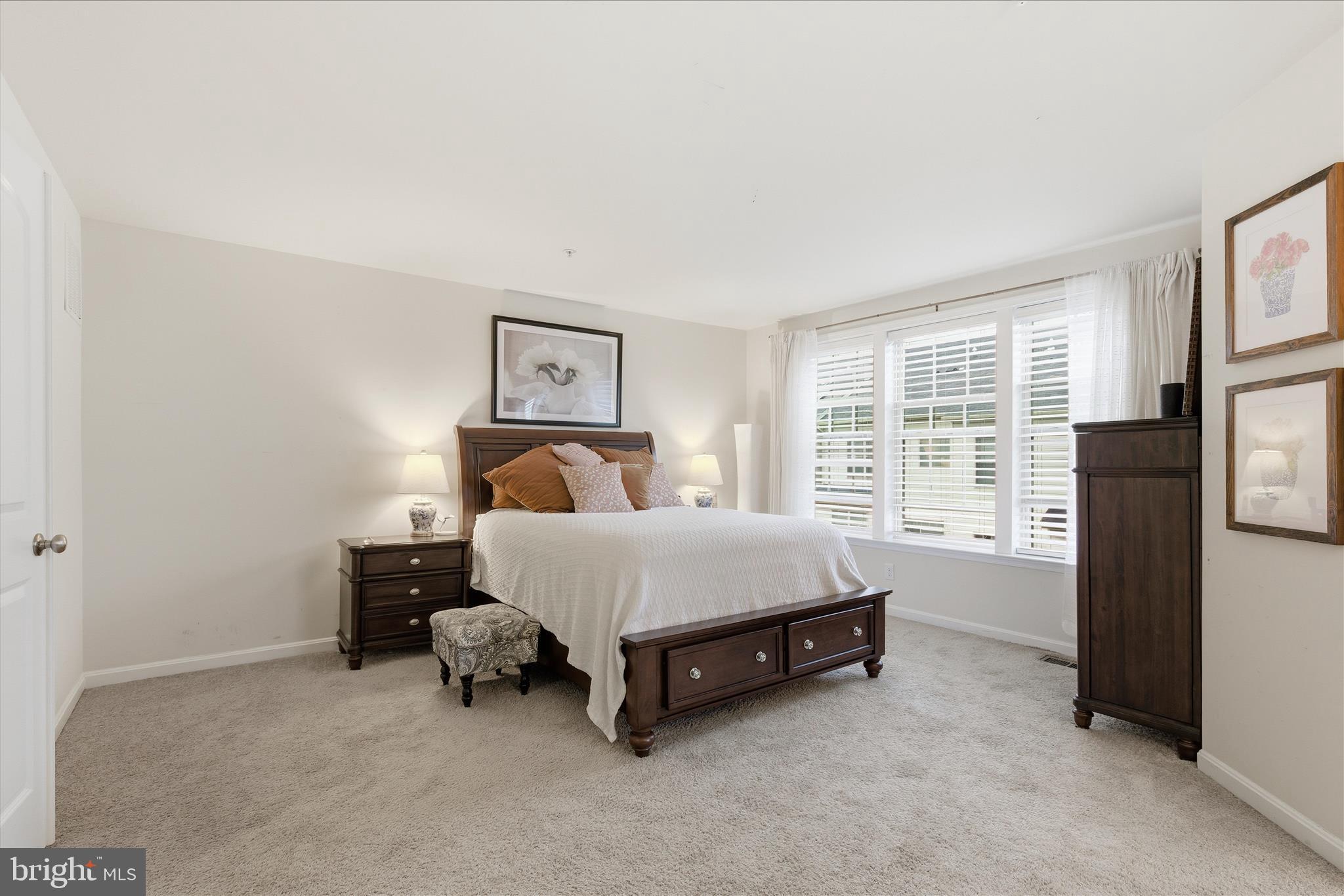 9511 Smithview Place Lanham, MD 20706 - Photo 22 of 33 a bed sitting in a bedroom next to a window with lamp
