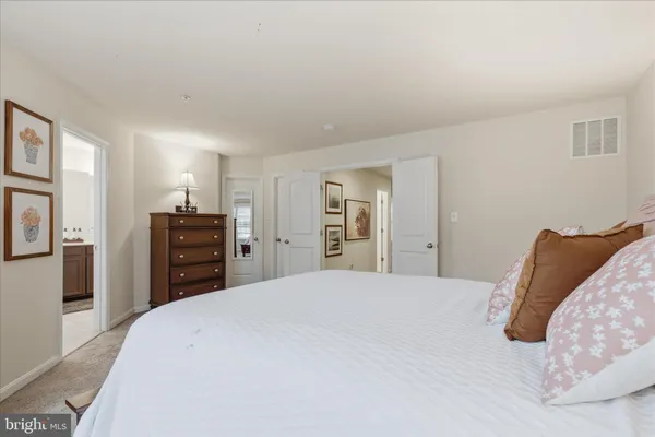 a bedroom with a large bed and a flat screen tv