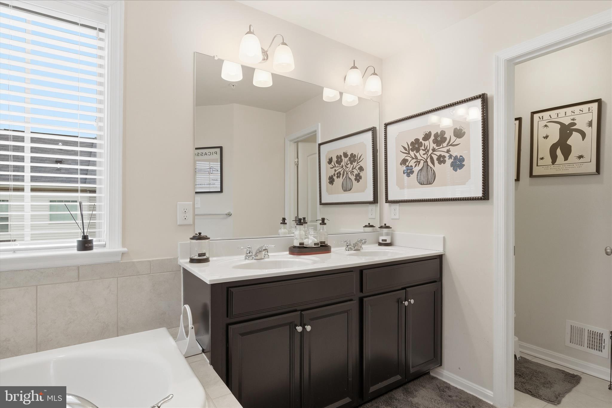 9511 Smithview Place Lanham, MD 20706 - Photo 25 of 33 a bathroom with a sink a large mirror and a window