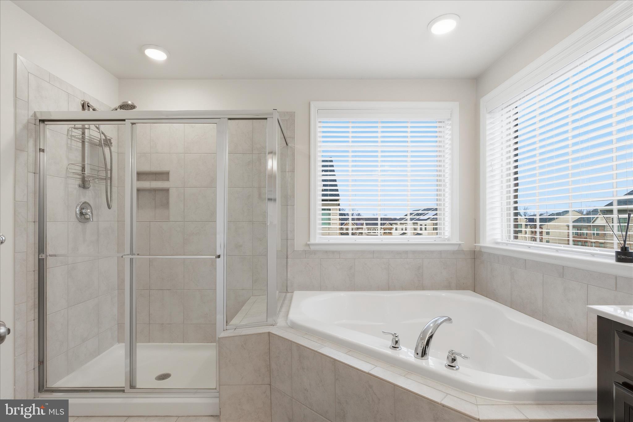9511 Smithview Place Lanham, MD 20706 - Photo 26 of 33 a bathroom with a bathtub a shower and a window