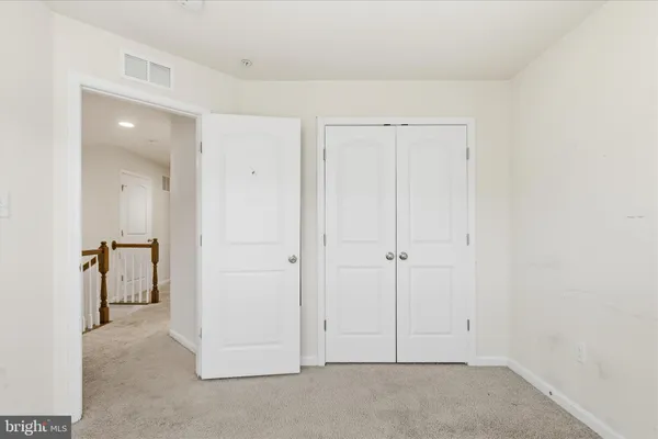 an empty room with closet area