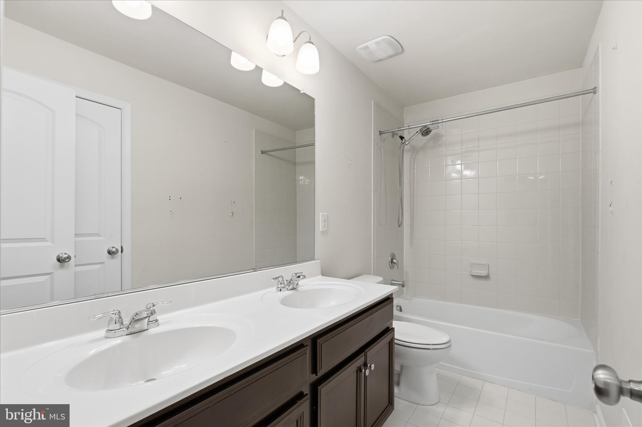 9511 Smithview Place Lanham, MD 20706 - Photo 29 of 33 a bathroom with a sink a toilet and shower