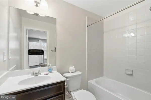 a bathroom with a sink toilet vanity and shower