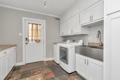 a utility room with sink dryer and washer