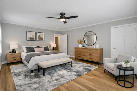 a bedroom with a bed a couch and dresser