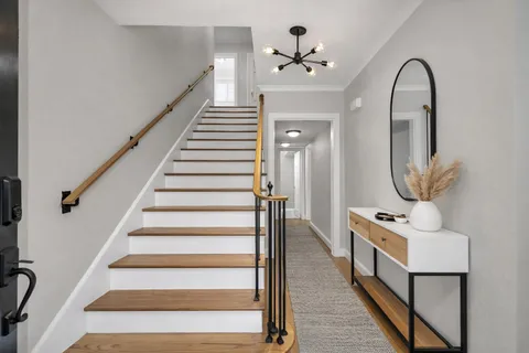 a view of entryway and hall with wooden floor