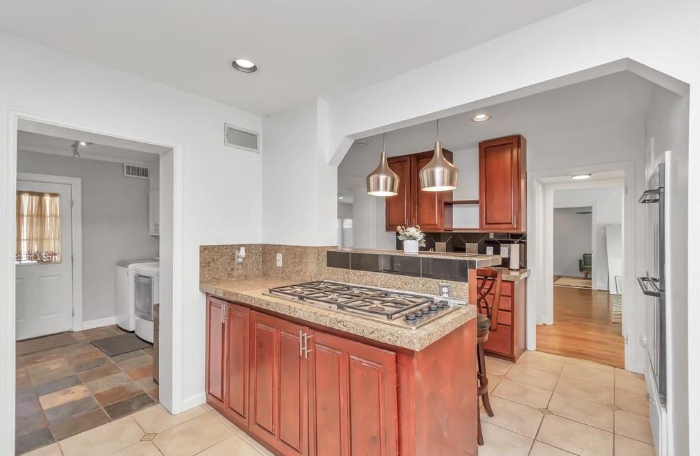 3215 Milburn Street Houston, TX 77021 - Photo 8 of 32 Current kitchen with gas cooking, island, and plenty of cabinetry and countertop space.