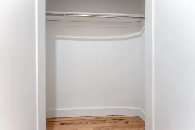 a view of walk in closet with empty racks