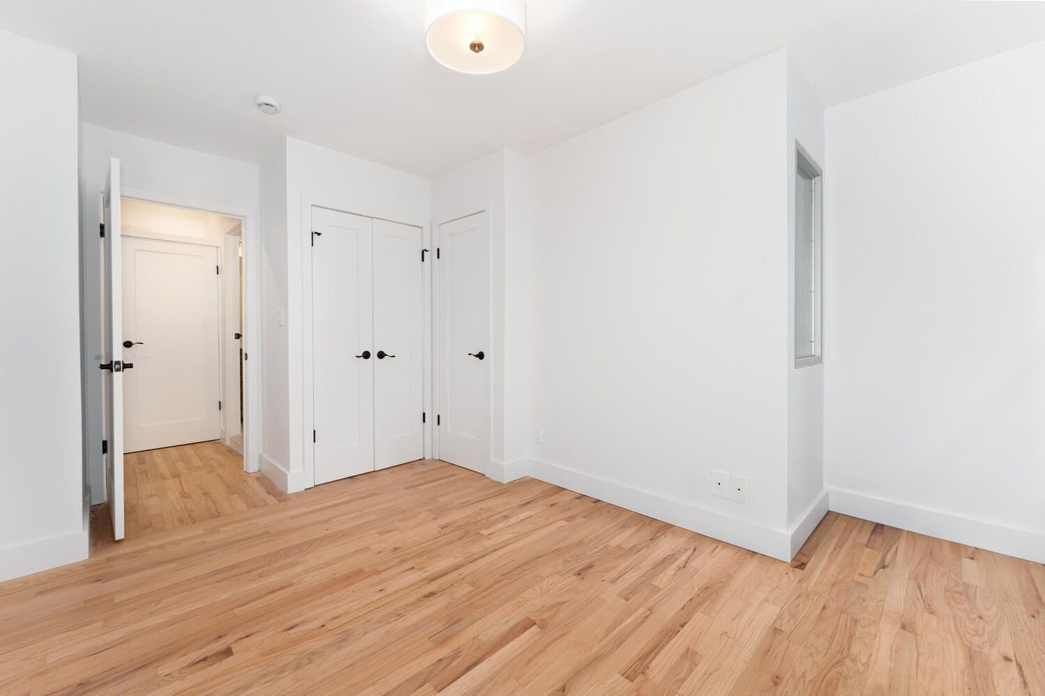 121 Division Street, Unit 2A Manhattan, NY 10002 - Photo 17 of 23 a view of a room with wooden floor
