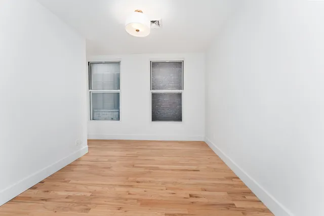 a view of a room with wooden floor