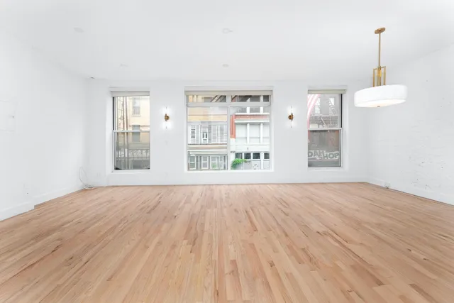 a view of a kitchen with a sink and a refrigerator