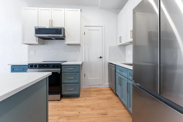 a kitchen with a stove sink and cabinets