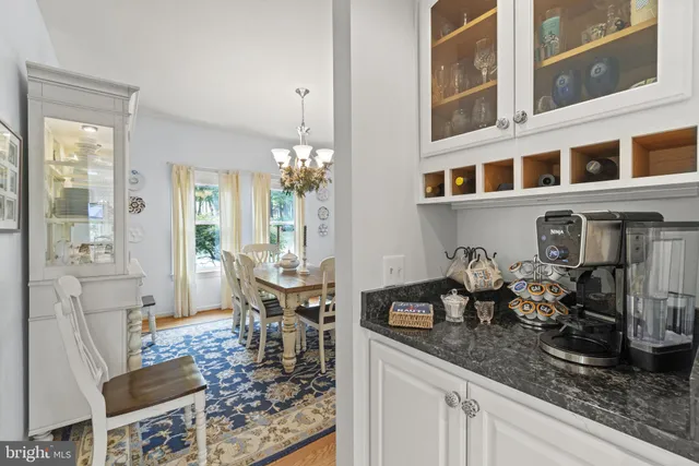 a kitchen with granite countertop kitchen island a counter space a sink appliances and cabinets