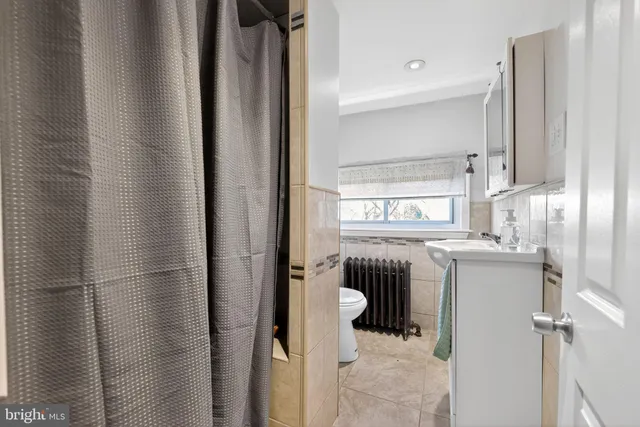 a bathroom with a window a sink and a shower