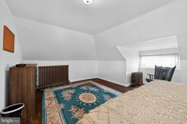 a bedroom with two beds and painting on the wall