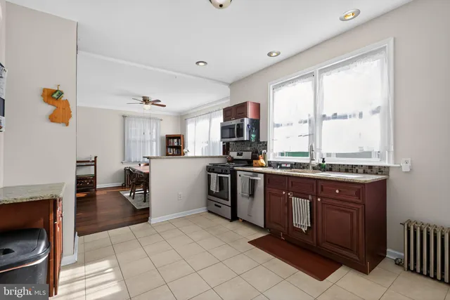 a kitchen with stainless steel appliances granite countertop a stove a sink dishwasher and a refrigerator